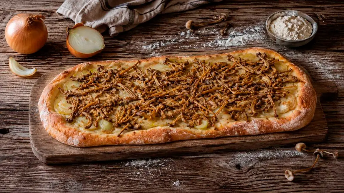 Coca casolana de carreretes i ceba sobre una taula de fusta, amb ceba tallada i una mica de farina al voltant.