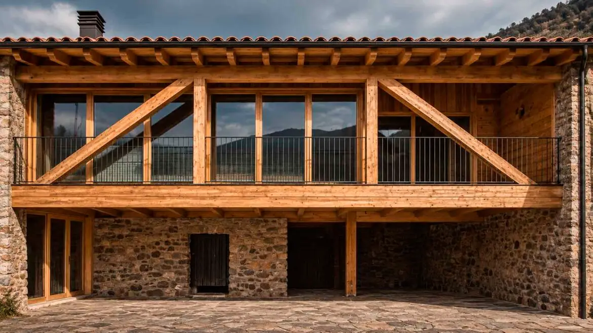 Antiga era rehabilitada com a habitatge contemporani, amb els murs de pedra i la gran estructura de fusta conservats i integrats en una façana oberta amb grans superfícies de vidre.